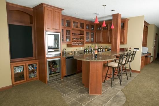 Zaxx home bar with cherry cabinets and a curved counter