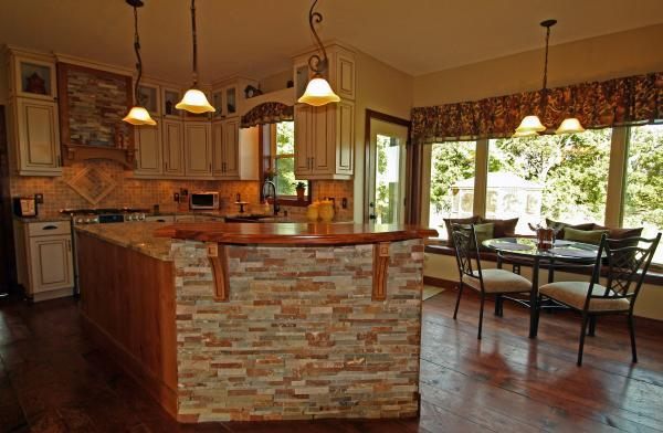 Zaxx kitchen with a stacked-stone island and wood bar top